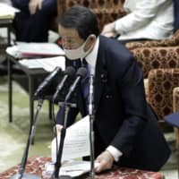 Earlier this month, Finance Minister Taro Aso claimed that Japan’s relatively low COVID-19 death rate is due to “the superiority of its people.” | BLOOMBERG