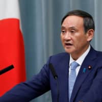 Chief Cabinet Secretary Yoshihide Suga said Wednesday that under the Constitution, striking an enemy base is allowed for self-defense if there are no other means. Suga made the remarks on the same day China asked Japan to maintain its \"exclusively defense-oriented\" policy.  | REUTERS