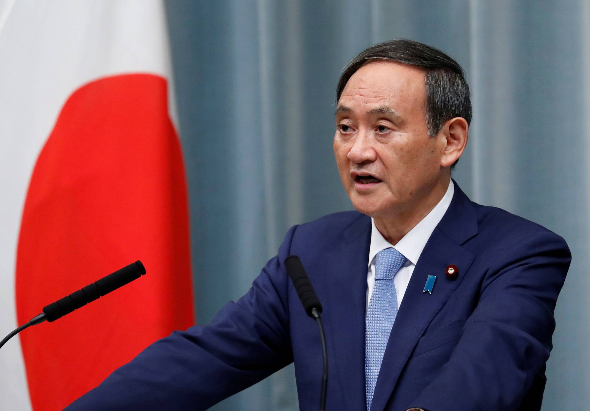 Chief Cabinet Secretary Yoshihide Suga said Wednesday that under the Constitution, striking an enemy base is allowed for self-defense if there are no other means. Suga made the remarks on the same day China asked Japan to maintain its 'exclusively defense-oriented' policy.  | REUTERS