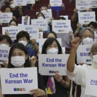 Anti-war activists demand peace on the Korean Peninsula on the eve of the 70th anniversary of the outbreak of the Korean War, in Seoul on Wednesday.  | AP