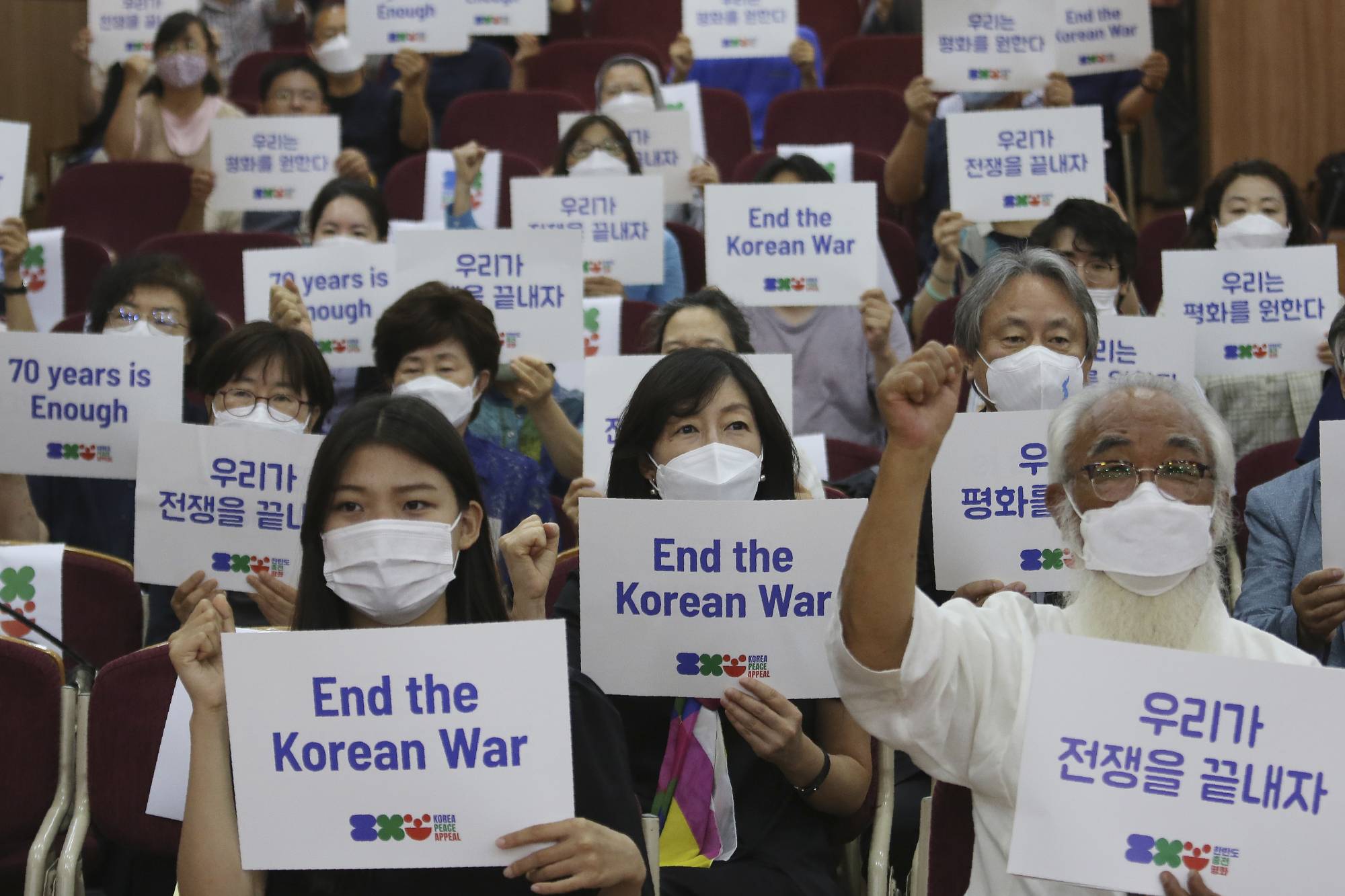 Anti-war activists demand peace on the Korean Peninsula on the eve of the 70th anniversary of the outbreak of the Korean War, in Seoul on Wednesday. | AP