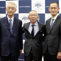 Fast Retailing Co. Chairman and CEO Tadashi Yanai (center) poses for a photo Wednesday with Nobel Prize winners Tasuku Honjo (left) and Shinya Yamanaka at Kyoto University. | KYODO