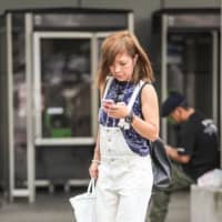Yamato on Thursday became the first municipality in Japan to attempt to stop people using their smartphones while walking outside in public places. | GETTY IMAGES / VIA KYODO