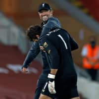 Liverpool manager Jurgen Klopp hugs keeper Alisson after a match against Crystal Palace Wednesday in Liverpool, England. | AFP-JIJI