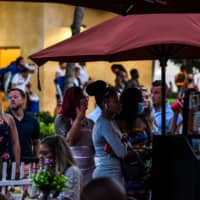 People stand in queue to enter a restaurant on Ocean Drive in Miami Beach, Florida on Friday. A brief fling with a more fulsome economic reopening, replicated in southern states like Florida and South Carolina, has boomeranged into a resurgence of novel coronavirus cases in the U.S. | AFP-JIJI