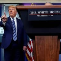 U.S. President Donald Trump stops a reporter from asking Dr. Anthony Fauci a question about use of the drug hydroxychloroquine to treat COVID-19, at the White House on April 5. | REUTERS 