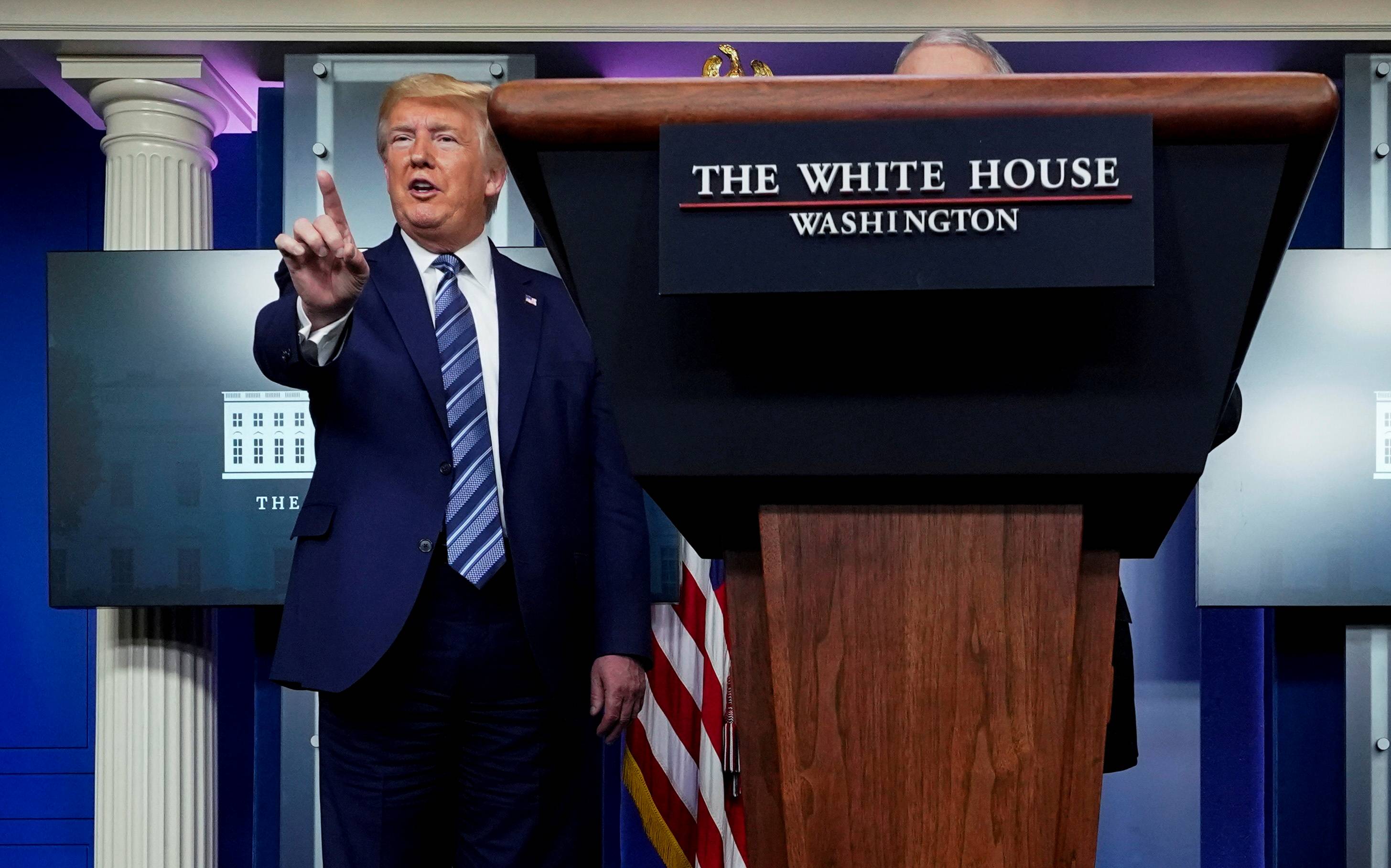 U.S. President Donald Trump stops a reporter from asking Dr. Anthony Fauci a question about use of the drug hydroxychloroquine to treat COVID-19, at the White House on April 5. | Reuters 