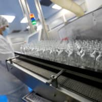 A lab technician works on remdesivir at an Eva Pharma facility in Cairo.  | REUTERS 