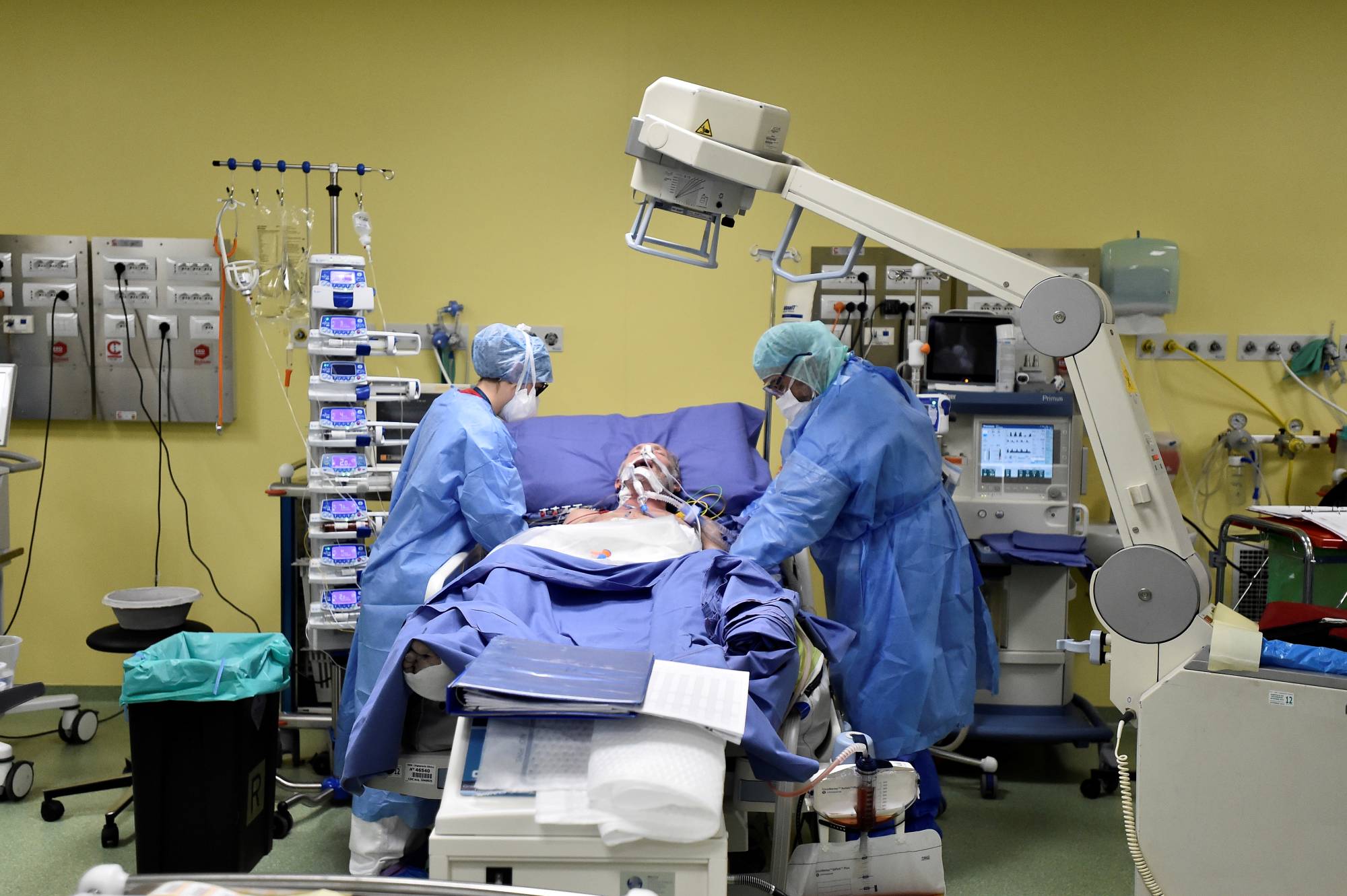 A patient suffering from COVID-19 is treated in an intensive care unit at the San Raffaele hospital in Milan, Italy, in March. | Reuters 