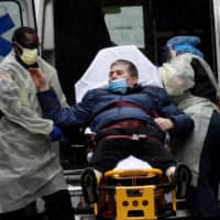 A patient is transported at the emergency entrance outside Mount Sinai Hospital in Manhattan in April.  | REUTERS 