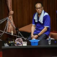 A lawmaker, part of a group consisting of more than 20 from Taiwan\'s main opposition party the Kuomintang, looks on while occupying the Legislative Yuan in Taipei on Monday. |  REUTERS