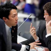 Environment Minister Shinjiro Koizumi, left, talks with Brazil’s Environment Minister Ricardo Salles at the U.N. Climate Change Conference (COP25) in Madrid in December 2019. | REUTERS