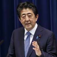 Prime Minister Shinzo Abe\'s goal to raise the percentage of women in leadership posts to 30 percent by 2020 is expected to be pushed back up to a decade. | POOL / VIA AP