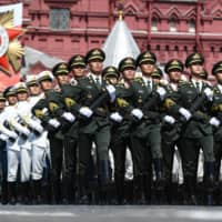 Soldiers of the China\'s People\'s Liberation Army march during the Victory Day Parade in Moscow on June 24. | POOL / VIA REUTERS