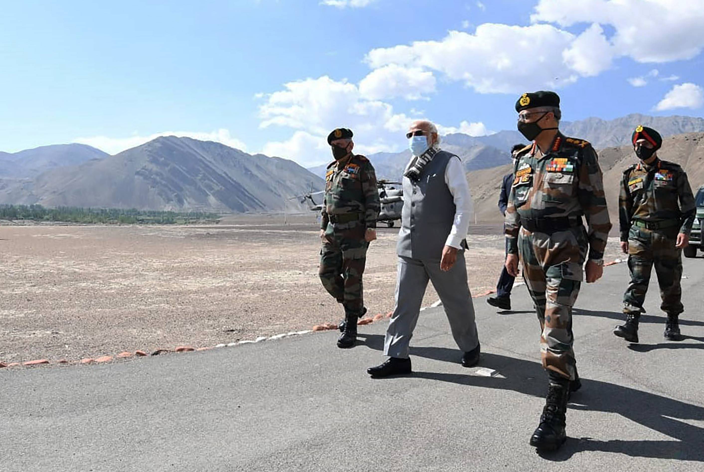 Indian Prime Minister Narendra Modi walks with soldiers during a visit to the Ladakh area of India on Friday. | PRESS INFORMATION BUREAU / VIA AP