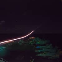 An F/A-18E Super Hornet launches from the flight deck of the USS Ronald Reagan aircraft carrier in the Philippine Sea on Tuesday night. | U.S. NAVY