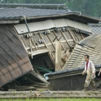 A house is collapsed in Kuma, Kumamoto Prefecture, on Sunday. | KYODO