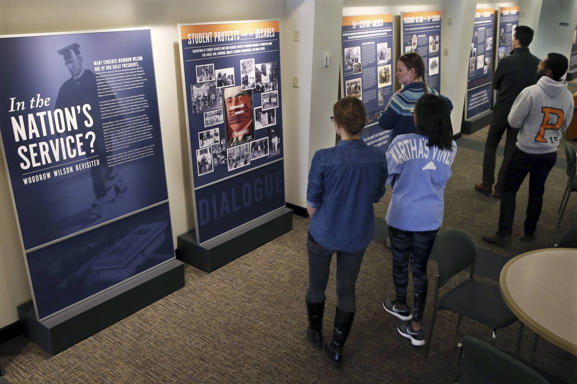 In this April 3, 2016 file photo, Princeton University students walk through an exhibit titled, 'In the Nation's Service? Woodrow Wilson Revisited,'  at the Woodrow Wilson School of Public and International Affairs in Princeton, N.J.   Princeton University has announced plans to remove the name of former President Woodrow Wilson from its public policy school because of his segregationist views, reversing a decision the Ivy League school made four years ago to retain the name.   | AP