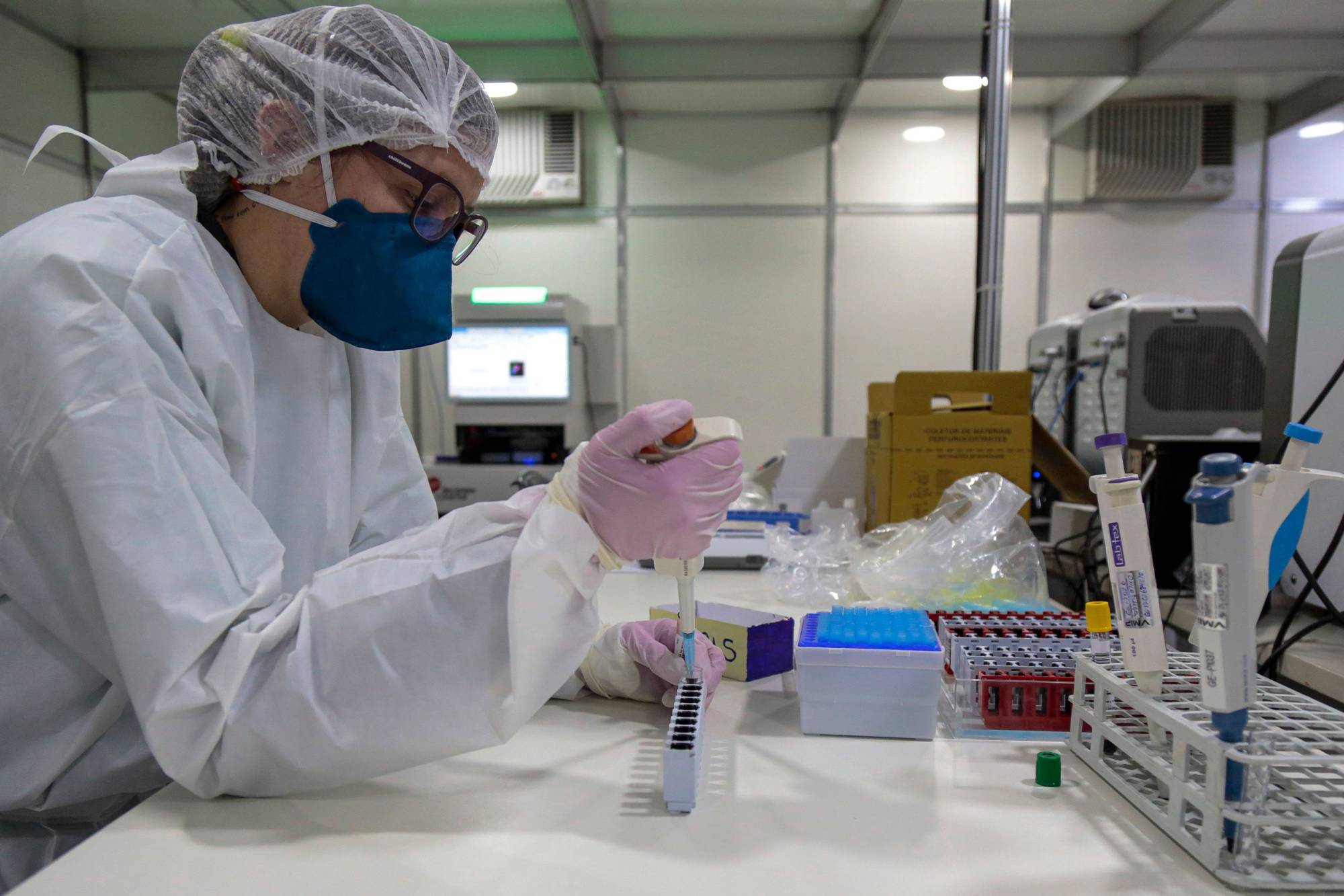 A health worker works with blood samples of COVID-19-infected patients in Sao Paulo on July 1. | AFP-JIJI