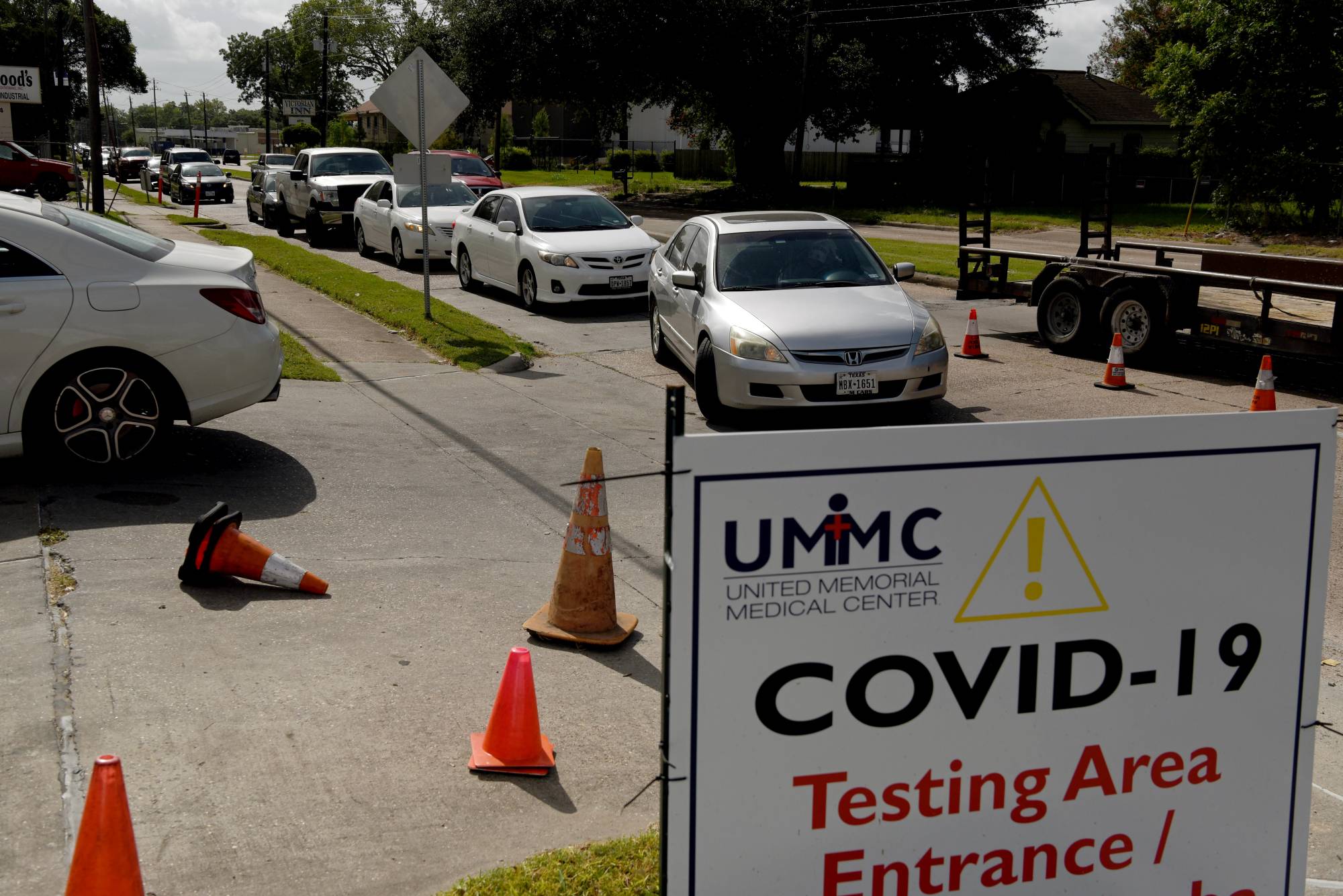 People wait in their vehicles to get tested for COVID-19 in Houston on Tuesday. | REUTERS