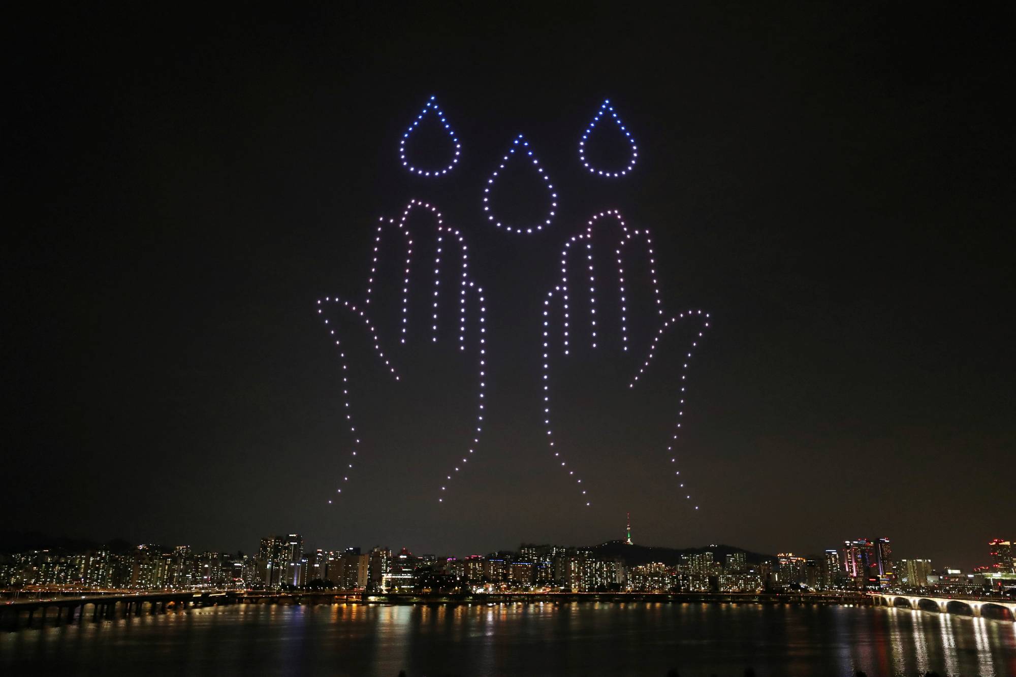 Drones in Seoul employed real-time kinematic satellite positioning with additional antennae to increase accuracy as part of a project to spread messages about COVID-19. | Yonhap / via REUTERS