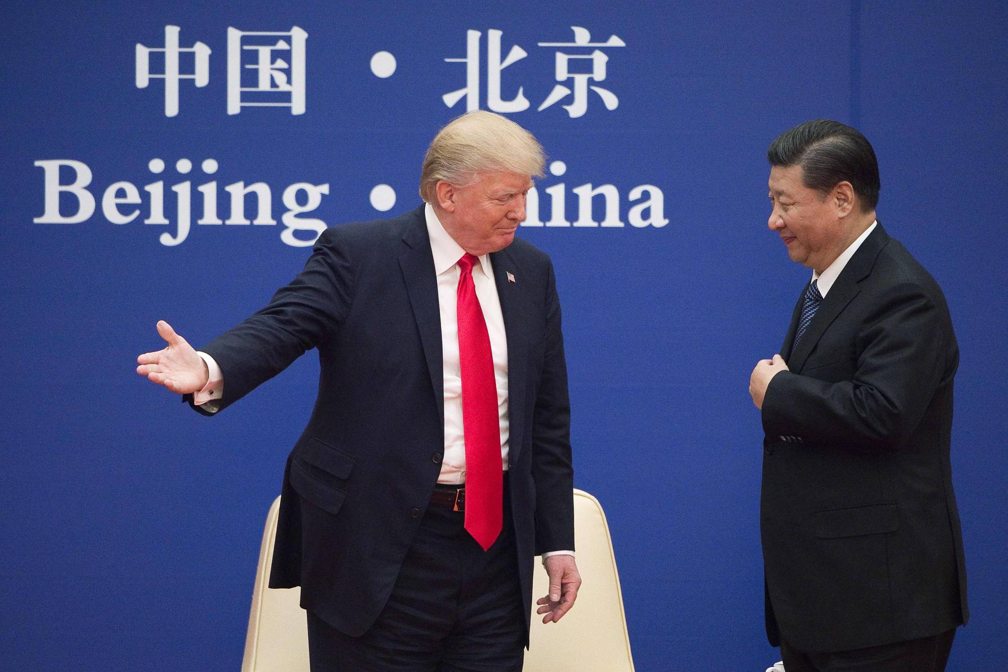 U.S. President Donald Trump and Chinese President Xi Jinping speak during a business leaders event in Beijing in November 2017.  | AFP-JIJI