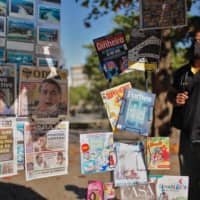 Newspapers reporting about Brazilian President Jair Bolsonaro testing positive for COVID-19 are displayed at a newsstand in Rio de Janeiro on Wednesday.  | AFP-JIJI