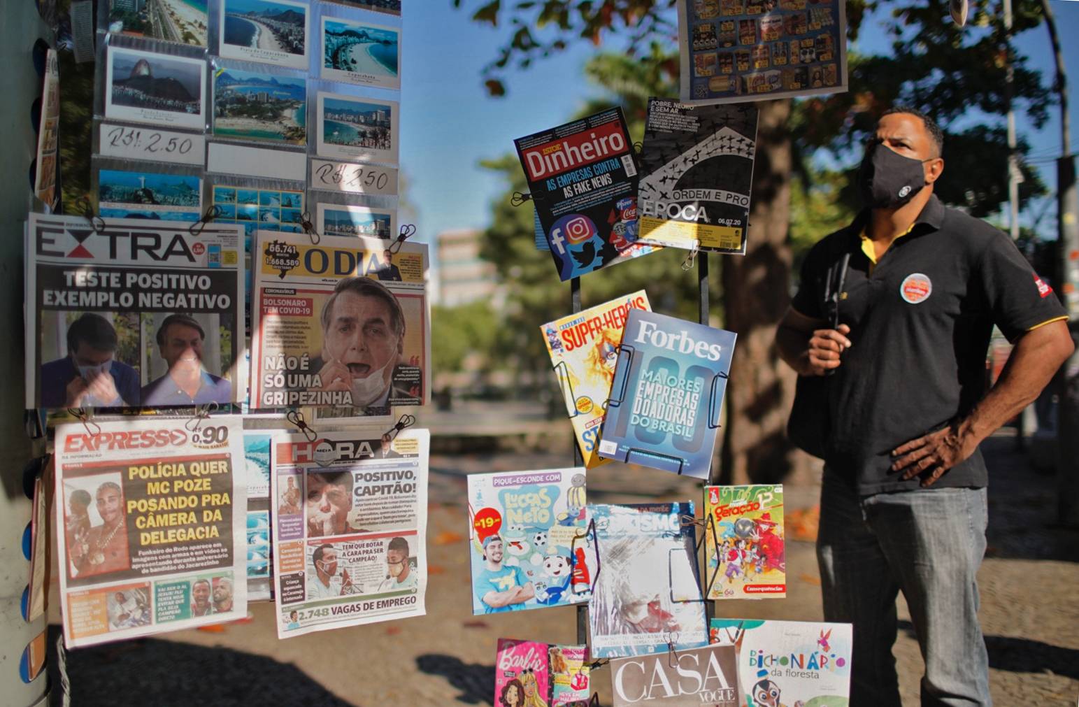 Newspapers reporting about Brazilian President Jair Bolsonaro testing positive for COVID-19 are displayed at a newsstand in Rio de Janeiro on Wednesday. | AFP-Jiji