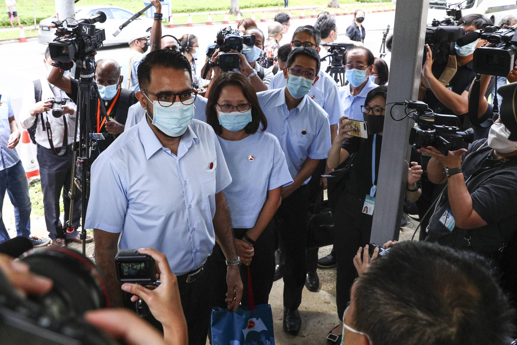 Workers' Party Secretary-General Pritam Singh (left) and Chairman Sylvia Lim (second left) arrive at a nomination center with their team to submit their nomination papers on June 30 for the general election in Singapore.  | AP