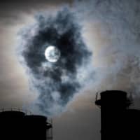 Sun shines through steam rising from chimneys of a power plant in Moscow in November. Global temperatures will continue to warm over the next five years, and may even temporarily rise to more than 1.5 degrees Celsius above pre-industrial levels, the World Meteorological Organization (WMO) said Thursday. | REUTERS