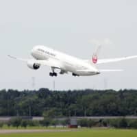 A chartered flight carrying Japanese businesspeople leaves Narita Airport on Friday for Guangzhou, China. | KYODO