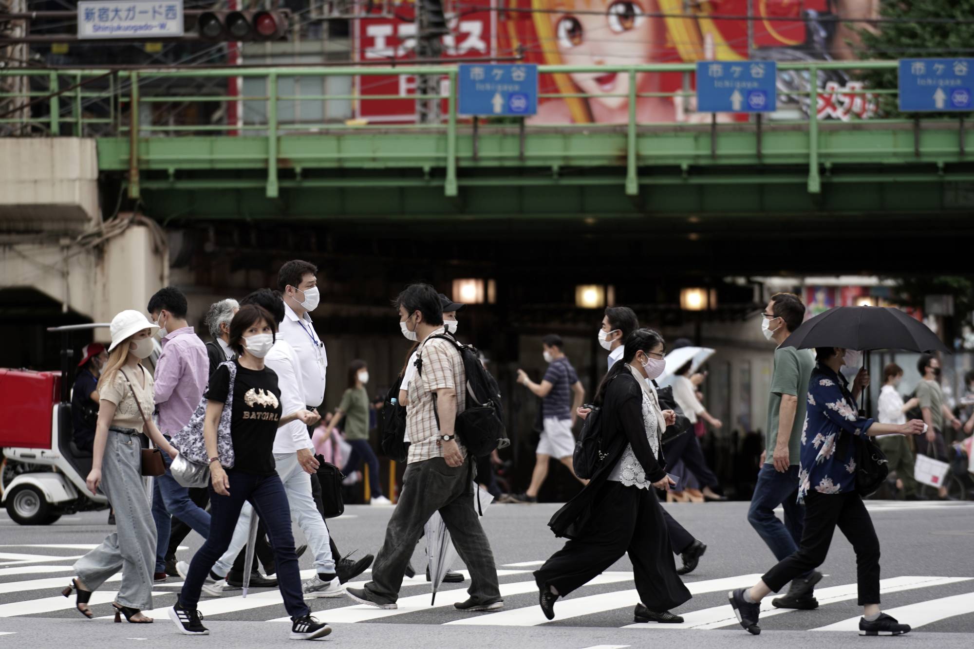 People cross a street Friday in Tokyo.  | AP