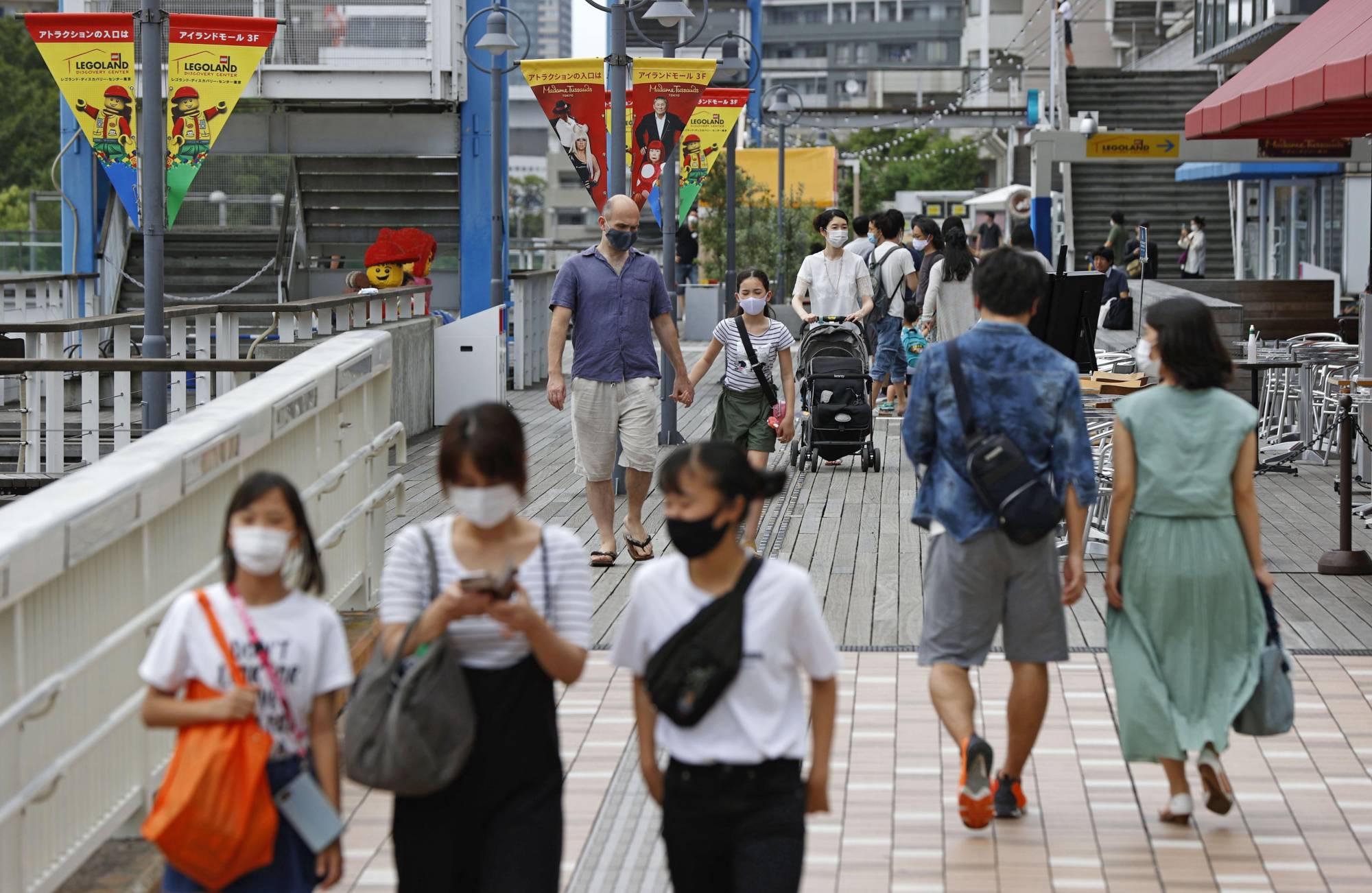 People walk in Tokyo's Odaiba district on Saturday. | KYODO