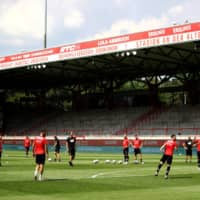 Fortuna players warm up before a game at Stadion An der Alten Forsterei, home of Union Berlin, on June 27 in Berlin. | POOL / VIA REUTERS
