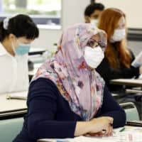 Foreign people attend a training session in Sendai on Saturday to learn how to help others from overseas in the event of a natural disaster. | KYODO