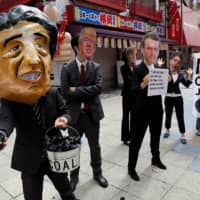 Protesters criticize the Japanese government\'s coal energy policy at the Group of 20 summit in Osaka on June 28, 2019. | REUTERS