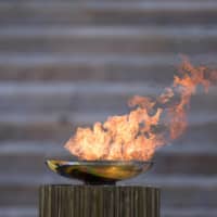 The Olympic flame is displayed during the handover ceremony in AThens on March 19. | POOL / VIA REUTERS