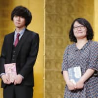 Haruka Tono (left) and Haneko Takayama pose at a Tokyo hotel after winning the Akutagawa Prize on Wednesday. | KYODO