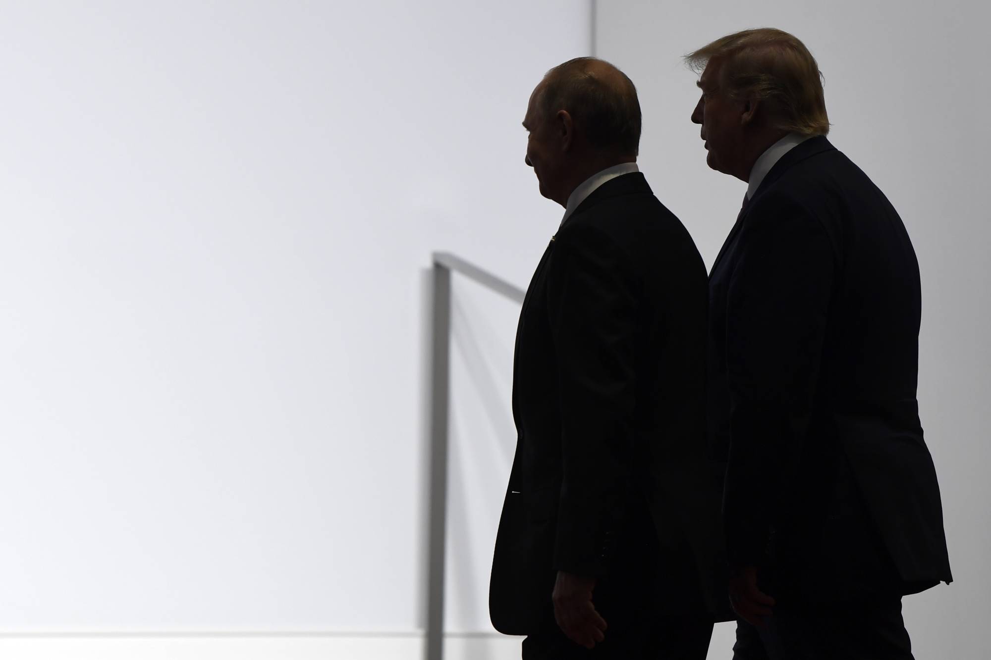U.S. President Donald Trump and Russian President Vladimir Putin walk together in Osaka in June 2019.  | AP