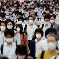 The voluntary widespread use of face masks in Japan has helped curb the spread of COVID-19. | REUTERS