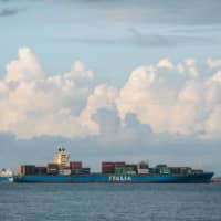 Container ships and tankers are seen off the coast in Singapore on Monday. A total 51 acts of piracy were reported in Asian waters in the January to June period, 50 of which were actual and one was an attempt, according to data from ReCAAP ISC, a piracy information group with 20 member nations, mostly in Asia.  | BLOOMBERG