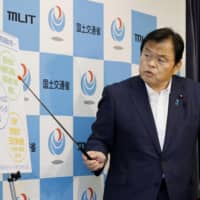 Tourism minister Kazuyoshi Akaba explains the Go To Travel Campaign, which is designed to reboot the coronavirus-stricken economy by sparking tourism, in Tokyo on Friday. | KYODO