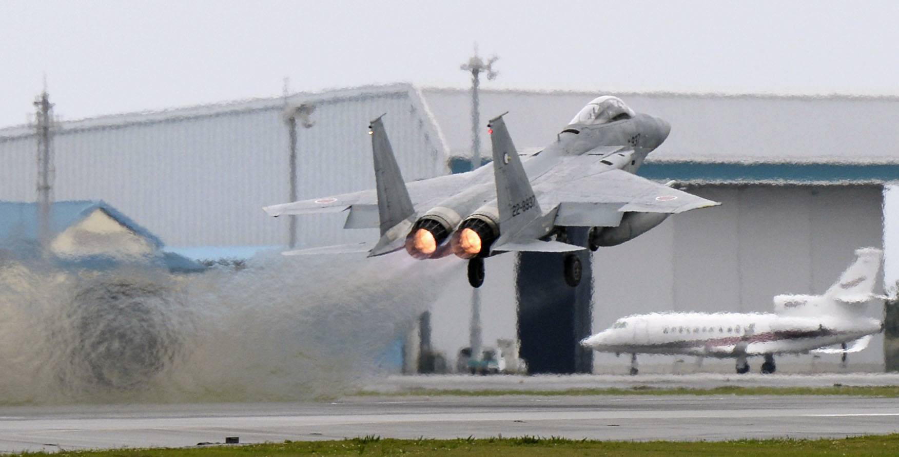 An F-15 fighter jet takes off from the Air Self-Defense Force base in Naha, Okinawa Prefecture, in April 2015. | KYODO
