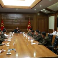 North Korean leader Kim Jong Un guides a Central Military Commission meeting in this photo released Sunday.  | KCNA / VIA REUTERS