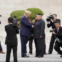 U.S. President Donald Trump meets with North Korean leader Kim Jong Un at the Demilitarized Zone separating the two Koreas, in Panmunjom, South Korea, on June 30 last year. | REUTERS