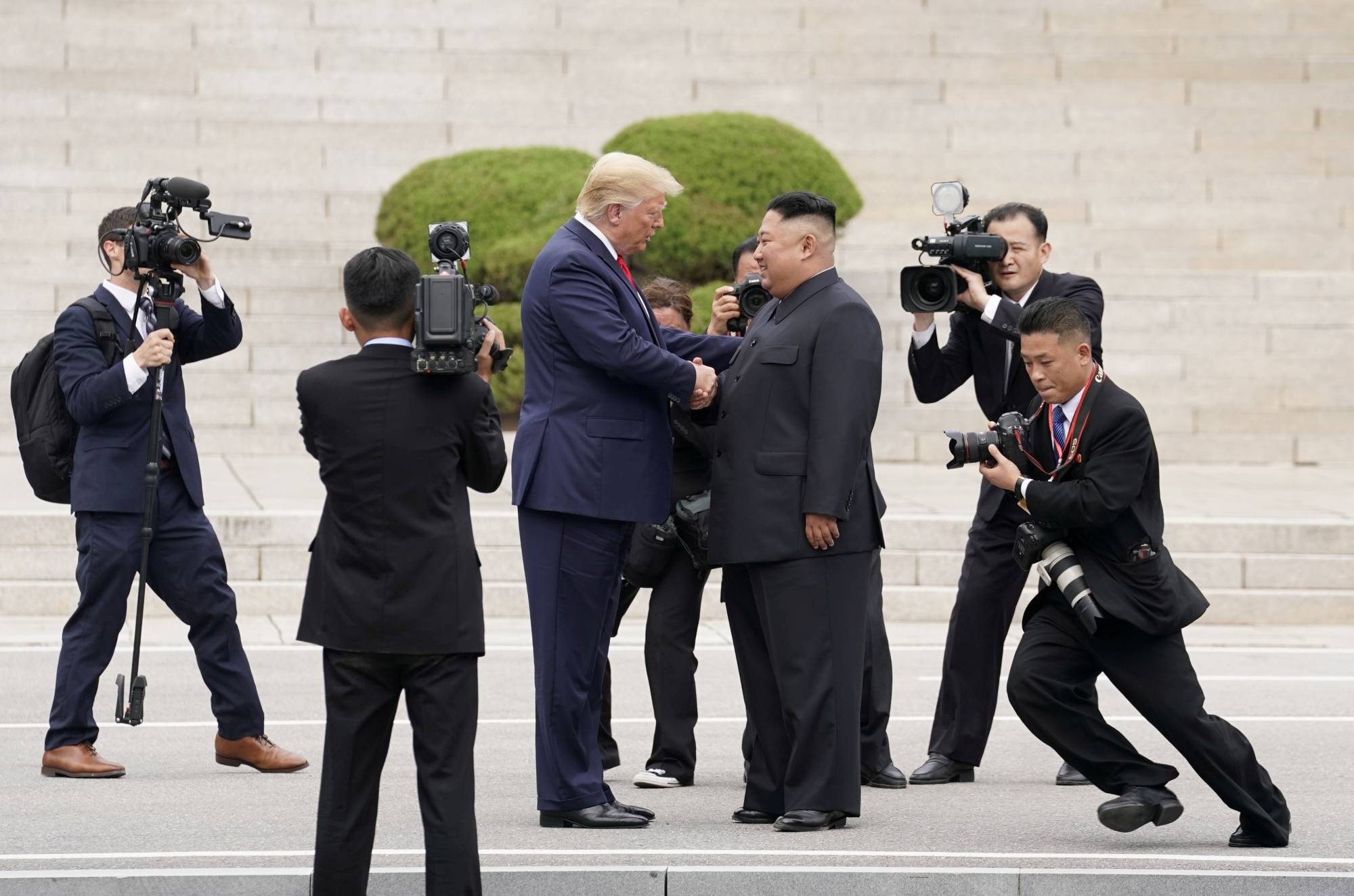 U.S. President Donald Trump meets with North Korean leader Kim Jong Un at the Demilitarized Zone separating the two Koreas, in Panmunjom, South Korea, on June 30 last year. | REUTERS