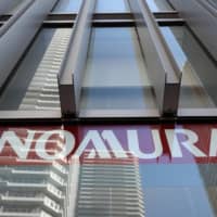 In a country where investors are used to paying commission, Nomura Holdings Inc. is looking to convince individuals to pay fees instead as it seeks to revive its retail business. A branch of the group\'s core brokerage, Nomura Securities Co., is seen in Kawasaki, Kanagawa Prefecture. | BLOOMBERG