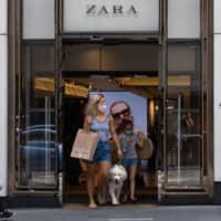 Shoppers exit a Zara clothing store in the Central district of Hong Kong on Sunday. | BLOOMBERG