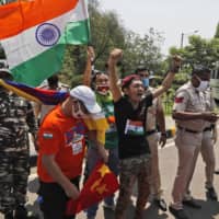 Exiled Tibetans shout their solidarity with India in the country\'s standoff with China over the Ladakh region during a protest outside the Chinese Embassy in New Delhi on July 11. | AP