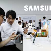 A salesman demonstrates a Samsung Electronics smartphone in Seoul. Companies in South Korea, with the aid of the government, are seeking out alternative methods to get around Japan\'s tightened export controls on special chemicals. | BLOOMBERG